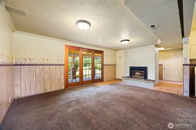 The lower level has a family room/rec room with a gas fireplace insert that opens out to the patio with overhead heaters.