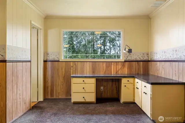 There is a built in desk at that alcove off the rec room, beside the half bath.