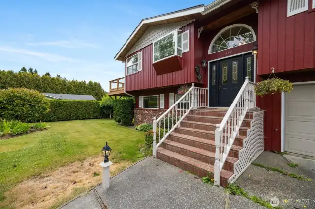 The home has brick accents and a brick stairway to the impressive front entry.