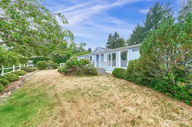 A beautifully mature yard surrounds the home with nature.