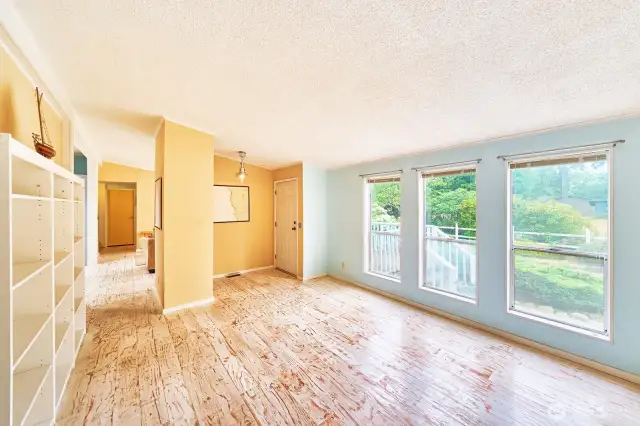 Enter to a "formal" living room with large windows looking out to the yard.