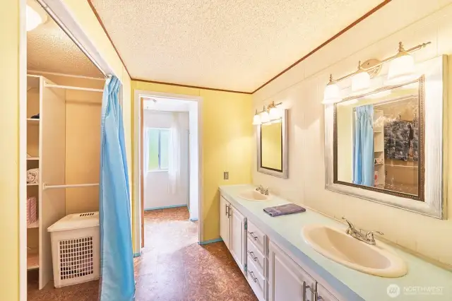 Handy double sinks separate from the primary bathroom, with large walk-in closet.