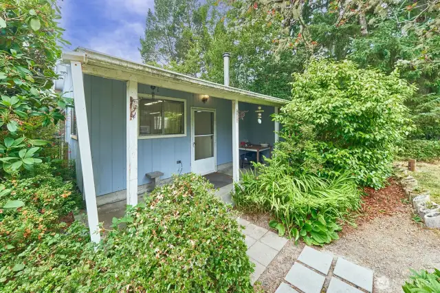 Garage/workshop has a covered porch.