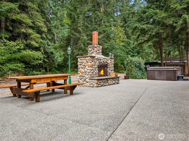 Spacious Patio off the Living Area with Gorgeous Stone Fireplace and Hot Tub.