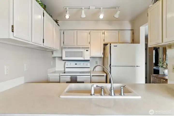 Kitchen is compact but well designed with plenty of counterspace and storage.
