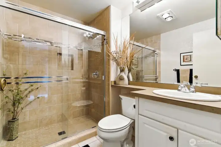 Updated bathroom with tiled walk-in shower.