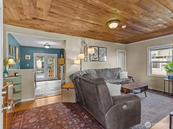 As you enter the home, you're warmly greeted by the beautiful cedar lined ceilings in the living room.