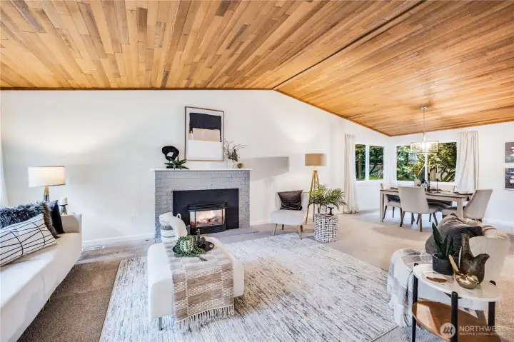 The cedar-lined vaulted ceiling soars above the gas fireplace and warm living area.