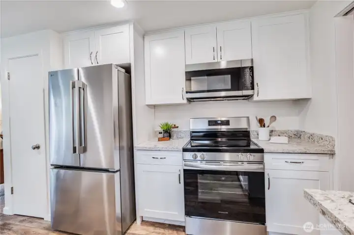 Plenty of cupboard space for small appliances, flatware, and stemware. A pantry is shown to the left.