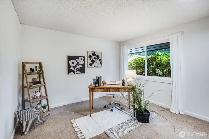 This main floor bedroom can serve as a home office or guest room. It looks out over the front yard.