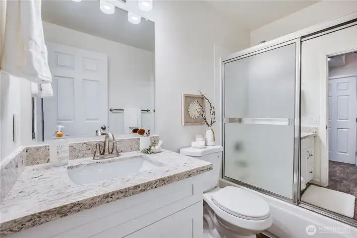 Adjacent to the main floor bedroom, and serving the main floor of the home, is this tastefully updated bathroom.
