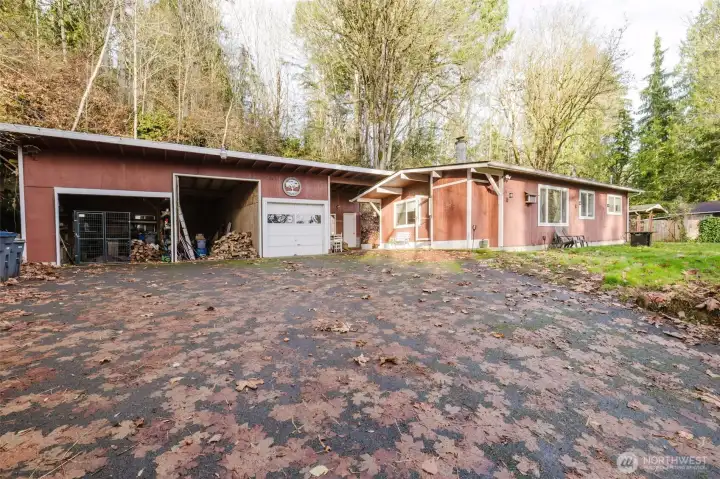 This home has a 3 car garage with room for an RV and parking for three cars!  Additionally there is an outbuilding for extra storage.  This home is secluded for added privacy but close to town for convenience.