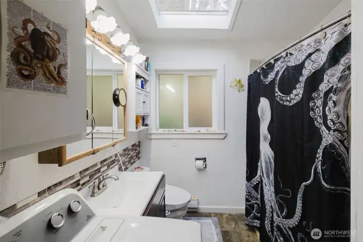 The laundry shares space with the full bathroom. All appliances stay with this home.