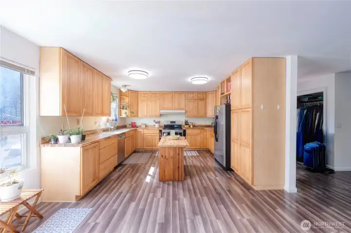 LARGE KITCHEN showcases generous cabinetry, butcher block counters and center island workspace.