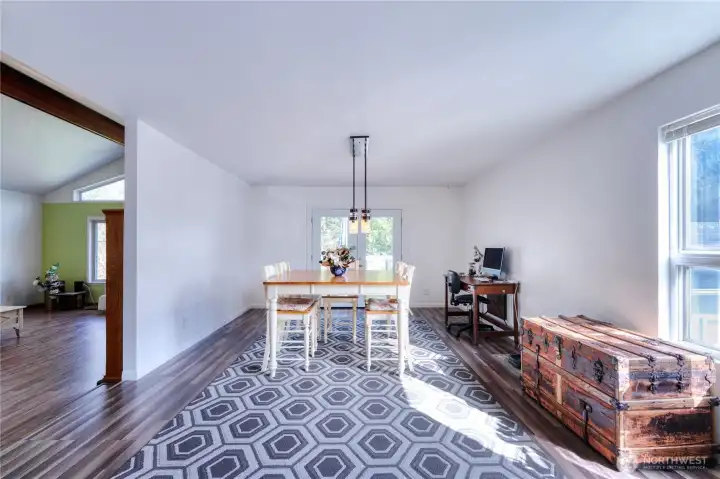 Expansive dining area ~ large enough to accommodate a full-length dining table, perfect for hosting gatherings.  French doors lead to a private deck.
