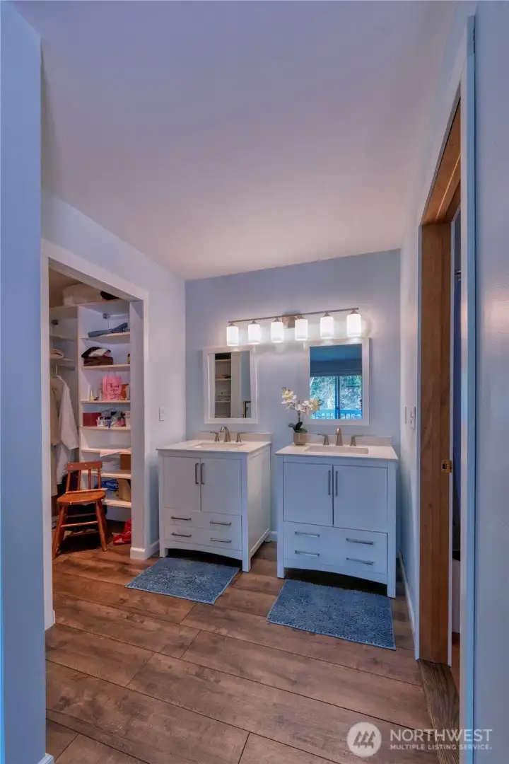 Primary offers new vanities w/dual sinks, mirrors and lighting. To the right is your full bath and to the left is your walk-in closet.