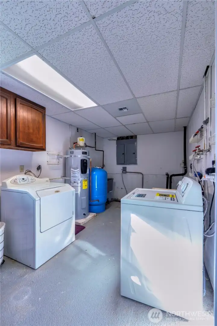 Laundry with utility sink, cupboards and dedicated folding area (not pictured).  NEW hot water heater.
