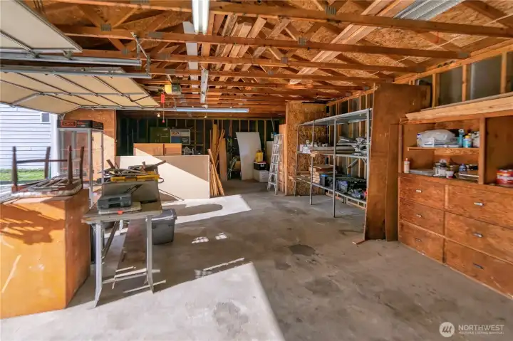 Multi-use shop with dual overhead doors providing excellent access for vehicles, equipment, or projects.