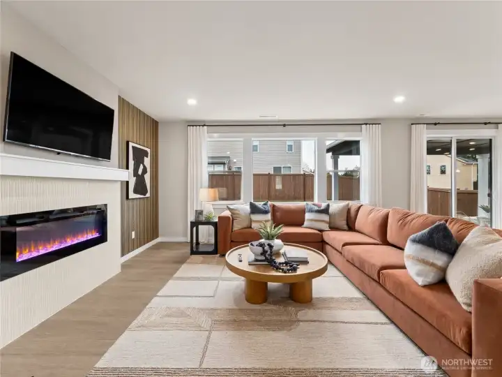 Great room with lots of windows to bring natural light int. Photo is representational. Actual home is under construction and finishes and colors will vary. See site agent for details.