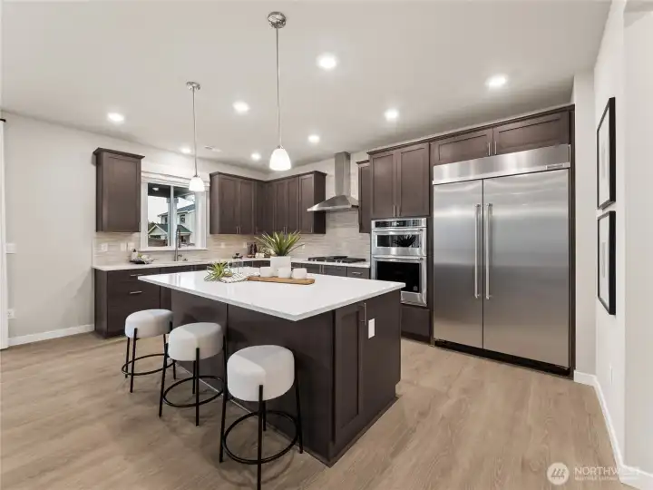 Gourmet Kitchen with upgraded appliances.   Check out the 48" included built-in Fridge. Photo is representational. Actual home is under construction and finishes and colors will vary. See site agent for details.