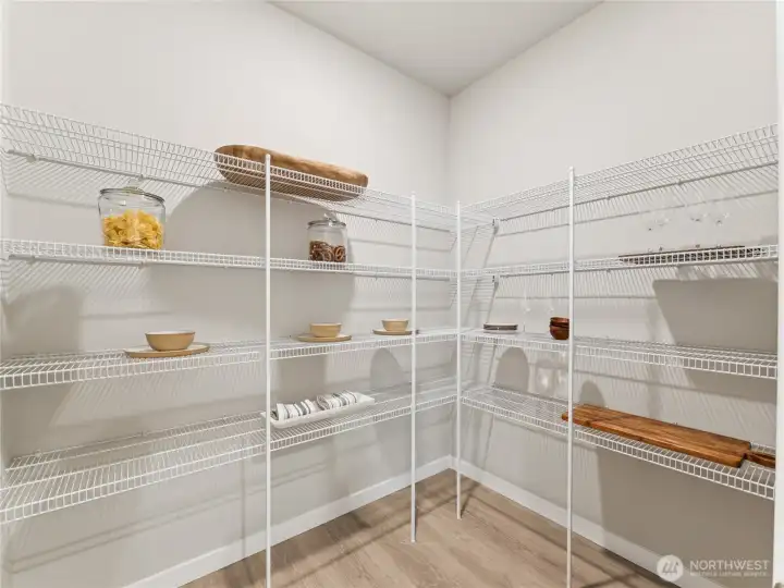 Large walk-in pantry off the kitchen/garage entry door.  Photo is representational. Actual home is under construction and finishes and colors will vary. See site agent for details.