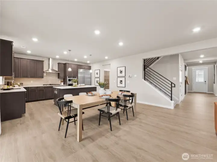 Looking towards the kitchen with eating space and staircase. Photo is representational. Actual home is under construction and finishes and colors will vary. See site agent for details.