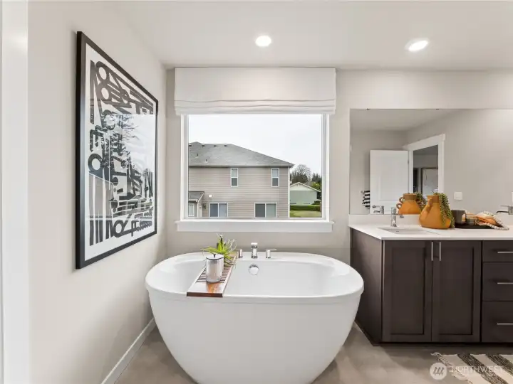 Beautiful soaking tub by the window. Photo is representational. Actual home is under construction and finishes and colors will vary. See site agent for details.