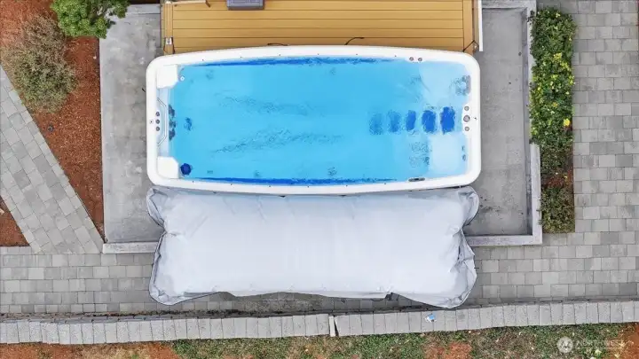 Powerful 17-foot Marquis ATV-17 Kona swim spa featuring six Whitewater-4 dual-speed swim jets, deep 53-inch water depth, and dual therapy seats for year-round fitness, relaxation, and family fun. Located off of Primary Suite's private deck.