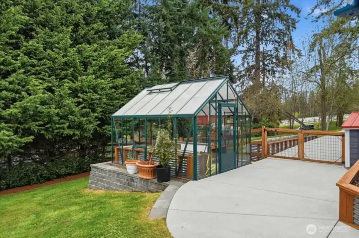 Greenhouse fitted with sprinkler system, electrical outlets and lights, allowing for extended growing seasons, or year round production.  A small starter table is built into one of the raised beds.  All soil, compost and fertilizes used were organic OMSI certified.
