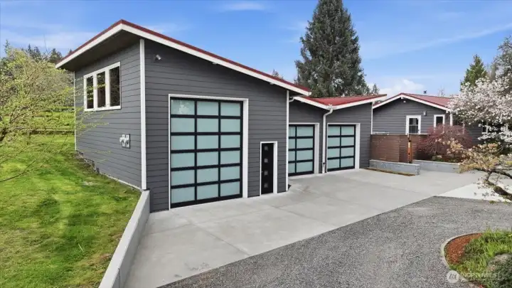 Detached garage with oversized shop/RV/boat indoor parking and a 10 wide x 12 high door.  On the roof are the 8.5 kw solar system panels.