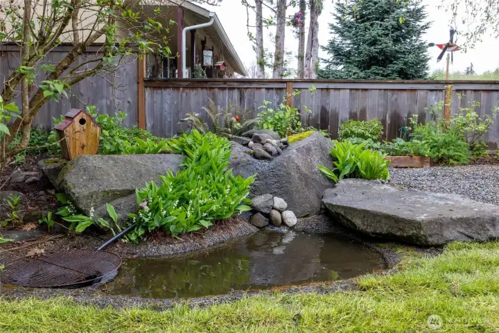 A functioning pond will create a sense of zen as you relax on your covered corner wrapped porch.