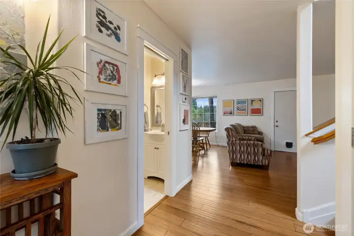 A convenient half bath located at the base of the stairs on the way to the kitchen, living & dining room.