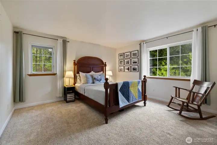 Spacious primary bedroom has air flow only dreams are made of.