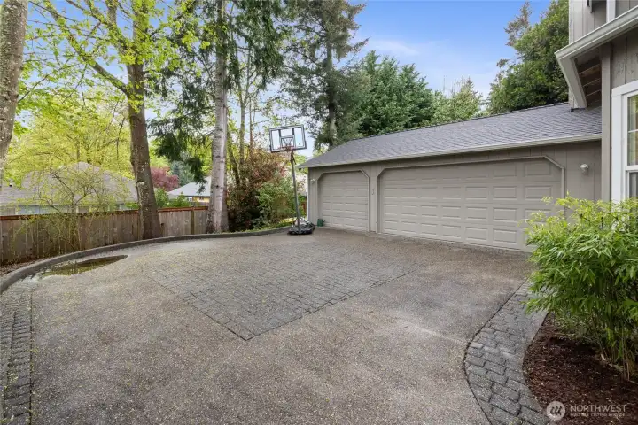 Graceful driveway allows for the maneuvering necessary for this three car garage.