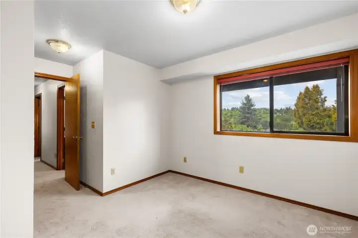 Lower level bedroom is tucked away from the rest of the home, providing privacy, and also has a pleasant view out of the window. There is a full bath right next to this bedroom, making it a perfect space for guests.