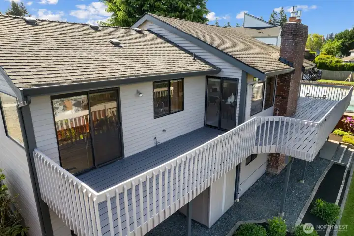 Huge Deck along entire back of the house. Can be accessed from kitchen nook, family room, and primary bedroom.