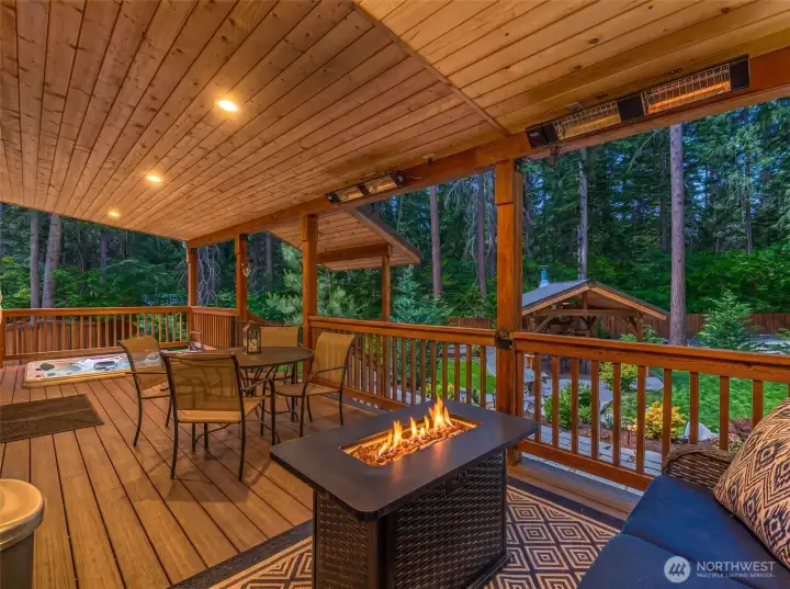 Large covered deck with hot tub, overhead heat and fire table - perfect for enjoying year-round