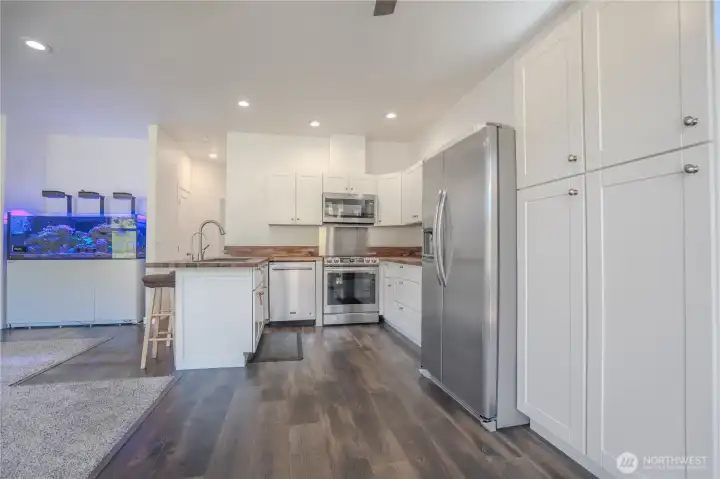 Osmosis water treatment system at kitchen sink. Nice stainless steel appliances.