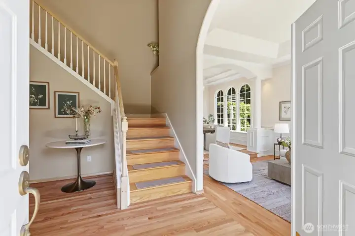 A breathtaking entry welcomes you with a stunning chandelier, soaring ceilings, and beautiful hardwood floors, creating an elegant introduction to this exceptional home. A breathtaking entry welcomes you with a stunning chandelier, soaring ceilings, and beautiful hardwood floors, creating an elegant introduction to this exceptional home.