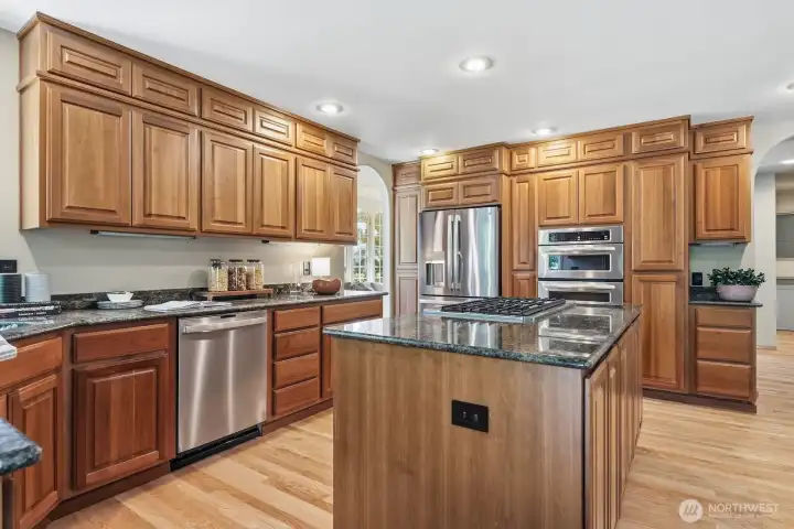 Designed for both everyday living and entertaining, the kitchen features granite countertops, a gas cooktop, custom cabinetry with convenient pull-out shelving, and plenty of workspace for preparing your favorite meals. Designed for both everyday living and entertaining, the kitchen features granite countertops, a gas cooktop, custom cabinetry with convenient pull-out shelving, and plenty of workspace for preparing your favorite meals.