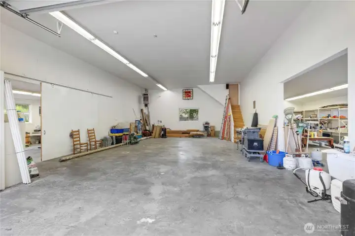 Detached Shop middle bay w/ oversized R.V. Height Door, stairs lead to additional storage space Detached Shop middle bay w/ oversized R.V. Height Door, stairs lead to additional storage space