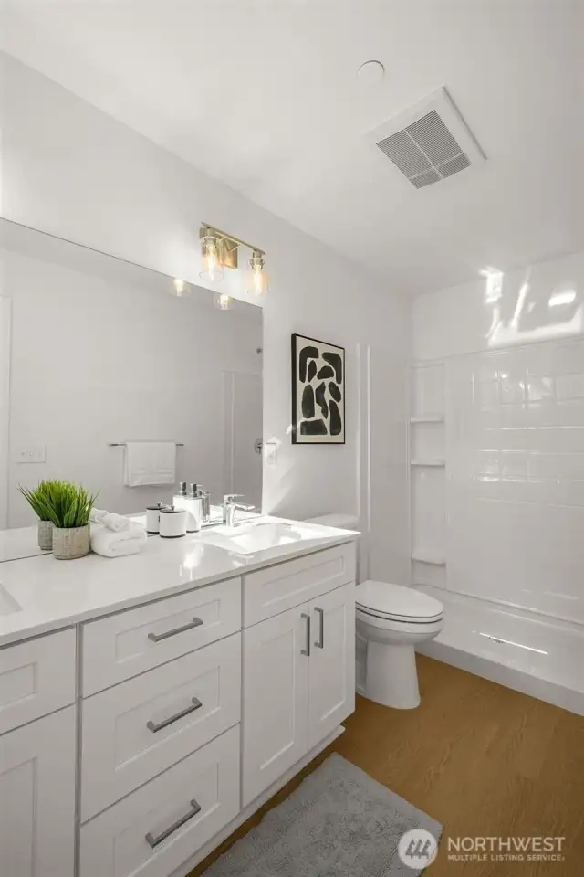 Morning routines just got an upgrade! This stylish bathroom features a sleek quartz vanity, modern fixtures, and a spa-like ambiance.