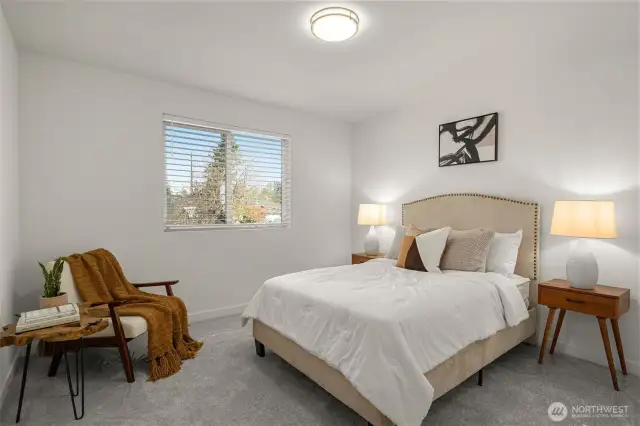 A guest bedroom so inviting your visitors may never want to leave! The oversized window brings in natural light, while plush carpeting and neutral tones create a restful, calming vibe.