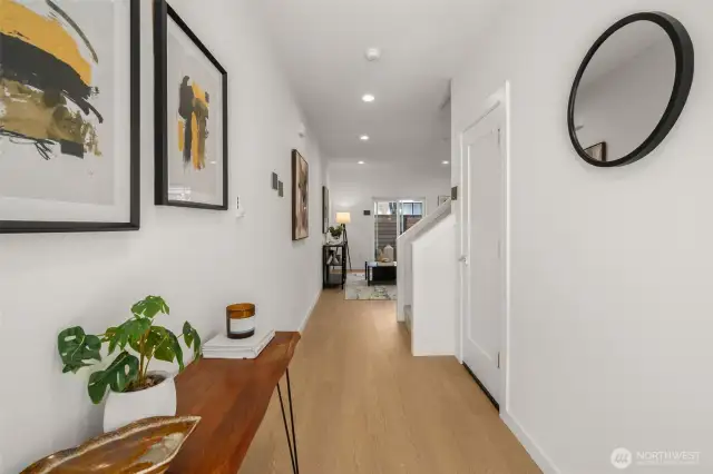 A grand entrance that makes a statement! This hallway welcomes you with warm wood tones, modern lighting, and an open flow leading to the heart of the home.