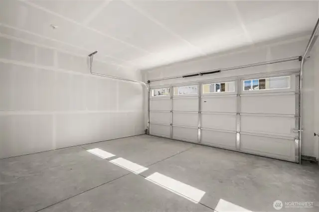 Spacious attached garage with a clean, finished look—ideal for parking, storage, or personal workshop space.