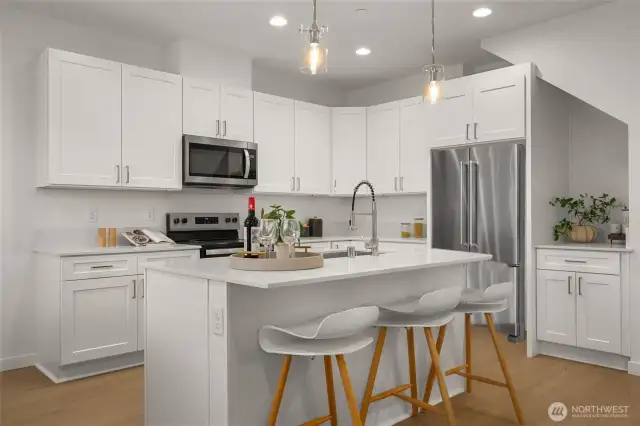With crisp white cabinetry, high-end stainless steel appliances, and an expansive quartz island, meal prep has never looked this good. Plus, there’s no shortage of storage!
