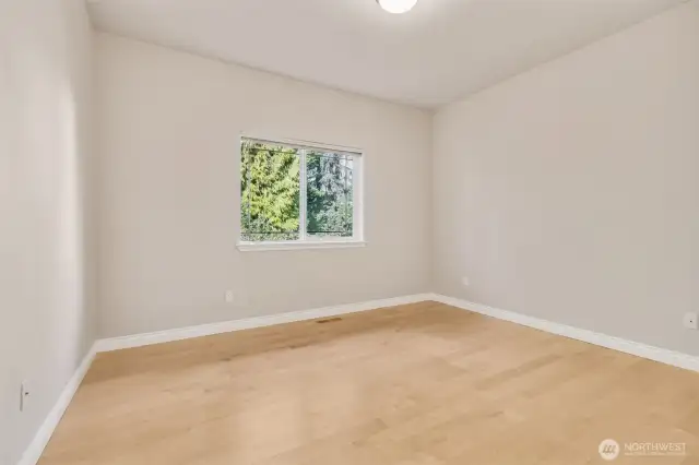 Bedroom 2.  Split bedroom design and view to backyard.
