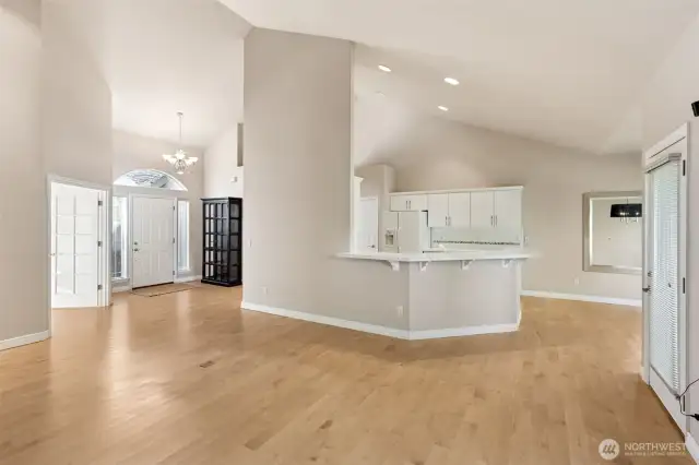 View of main living area and adjoining kitchen from fireplace area.