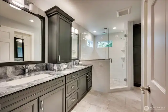 This luxurious bath has a custom storage tower and heated floors that extend through the closet. Don't miss the lovely view from the shower.