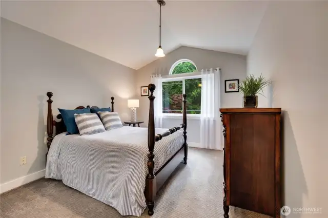 Bedroom 3 has vaulted ceilings and overlooks the home's entry landscaping.
